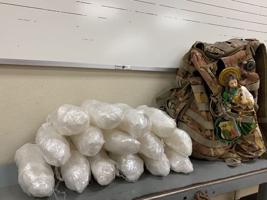 15 cellophane wrapped packages found inside smuggler's backpack.
