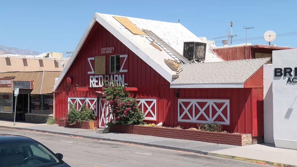 Message advertising the Red Barn is '4 Sale As Is' gets painted over