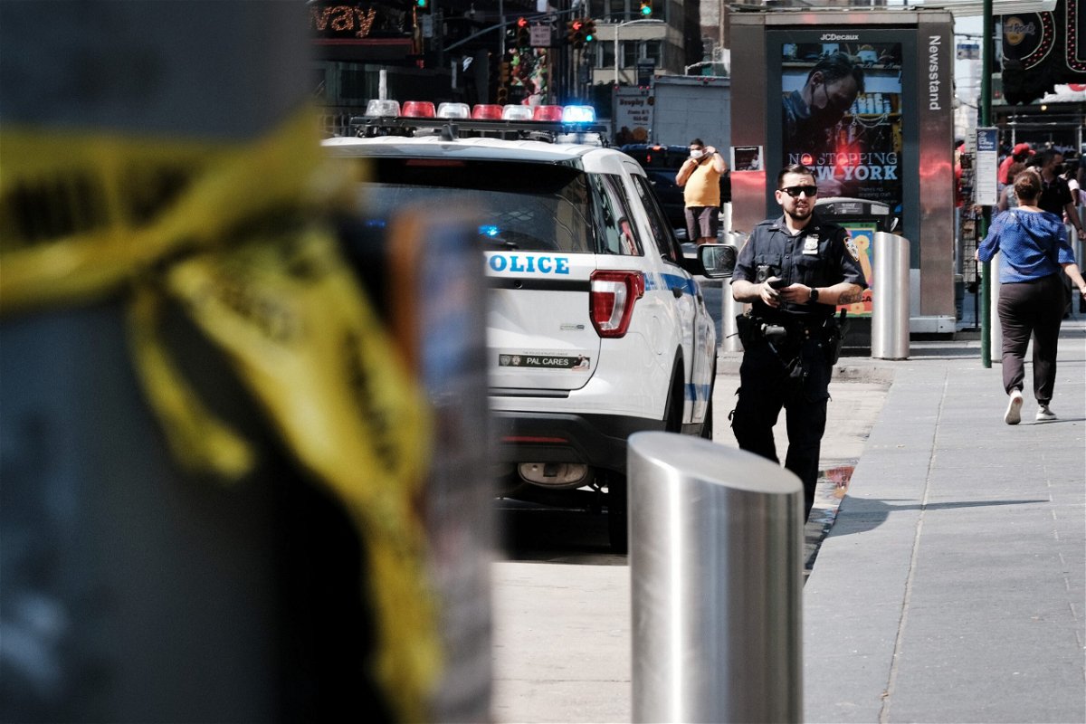 <i>Spencer Platt/Getty Images</i><br/>Police patrol in Times Square after a shooting there Saturday.