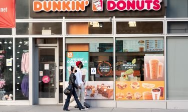 People walk outside Dunkin' Donuts in Hell's Kitchen amid the coronavirus pandemic on March 20 in New York City. Dunkin' has a fitting new treat for people breaking out of their personal bubbles after a long 15 months.