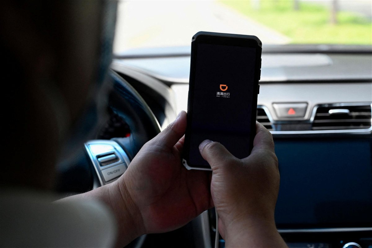 <i>Jade Gao/AFP/Getty Images</i><br/>A driver opens the Didi Chuxing ride-hailing app on his smartphone in Beijing on July 2. The Cyberspace Administration of China on July 4 banned Didi from app stores after saying it posed a cybersecurity risk for customers.