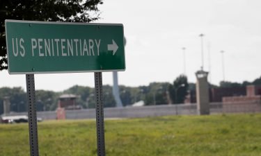 A sign directs visitors to the entrance of the Federal Correctional Complex Terre Haute in July 2019 in Terre Haute