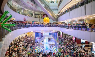People are shown at a shopping mall in Hong Kong watching Siobhan Haughey swim in the 100-meter freestyle Olympics final on Friday. Hong Kong police have arrested a man after he allegedly booed the Chinese national anthem while watching an Olympics award ceremony inside a shopping mall..
