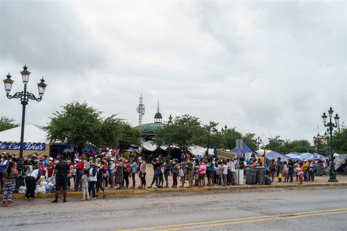 <i>Paul  Ratje/AFP/Getty Images</i><br/>Migrants who were sent back to Mexico under Title 42 wait in line for food and supplies in a camp across the US-Mexico border in Reynosa