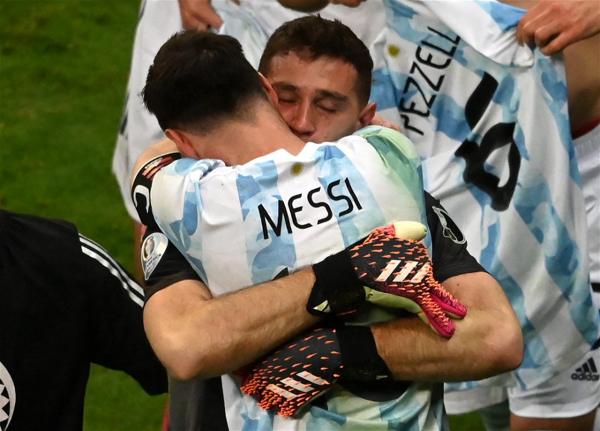 <i>EVARISTO SA/AFP/AFP via Getty Images</i><br/>Argentina's goalkeeper Emiliano Martinez and Argentina's Lionel Messi embraces Emiliano Martinez after the goalkeeper's shootout heroics.