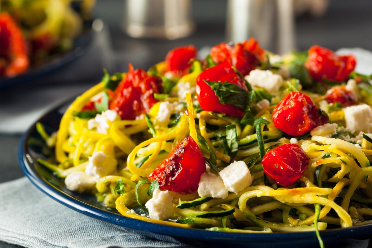 <i>Brent Hofacker/Alamy Stock Photo</i><br/>Zucchini noodle pasta is served here with tomatoes and feta.