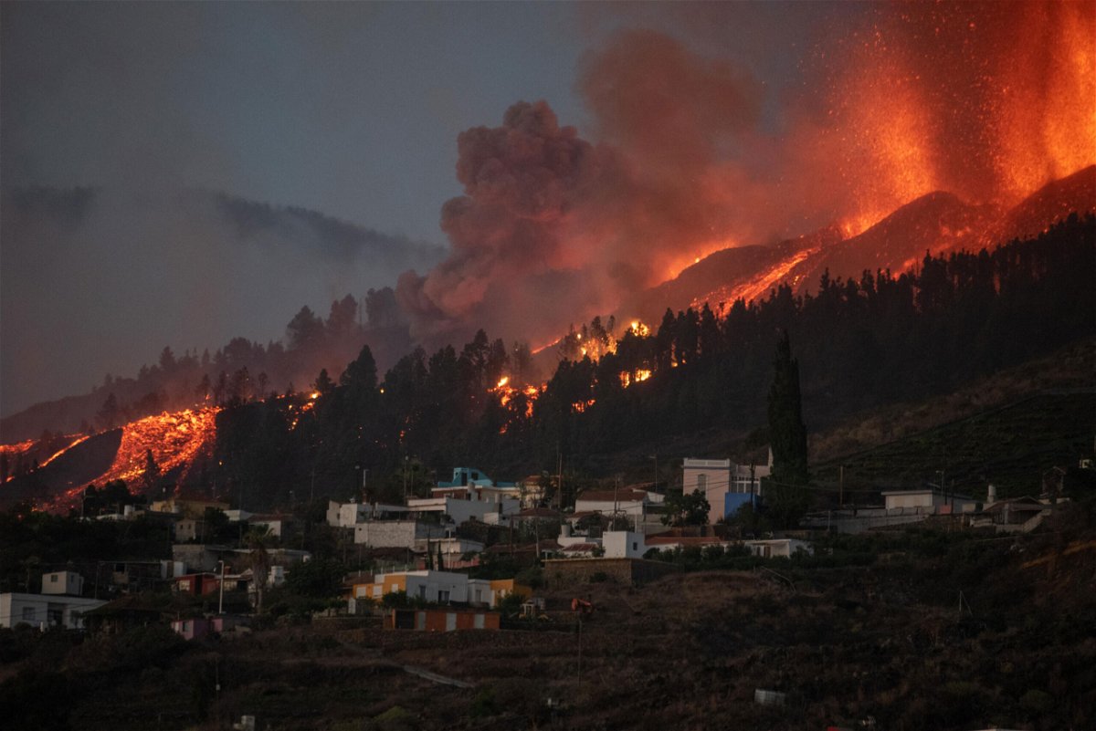 <i>Desiree Martin/AFP/Getty Images</i><br/>A river of lava flowing from the volcano approaches houses on Spain's La Palma island on Sunday.