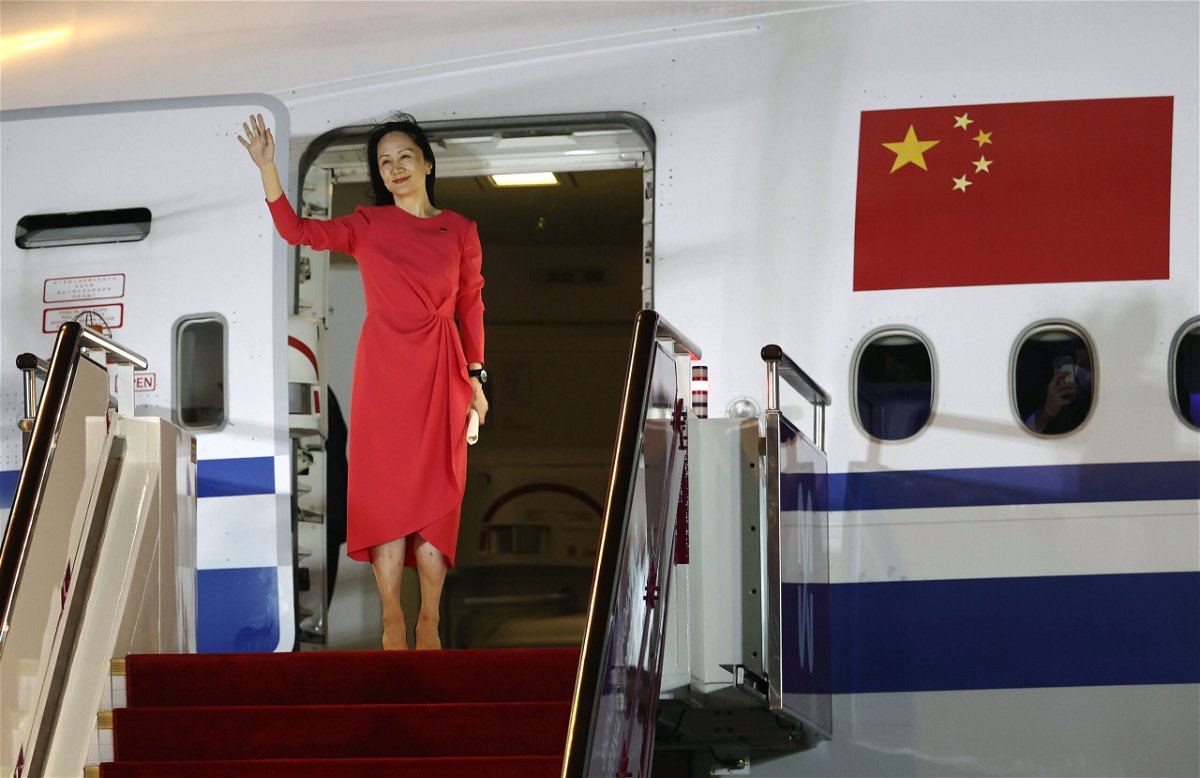 <i>Jin Liwang/AP</i><br/>Huawei executive Meng Wanzhou waves as she steps out of an airplane after arriving at Shenzhen Bao'an International Airport in Shenzhen