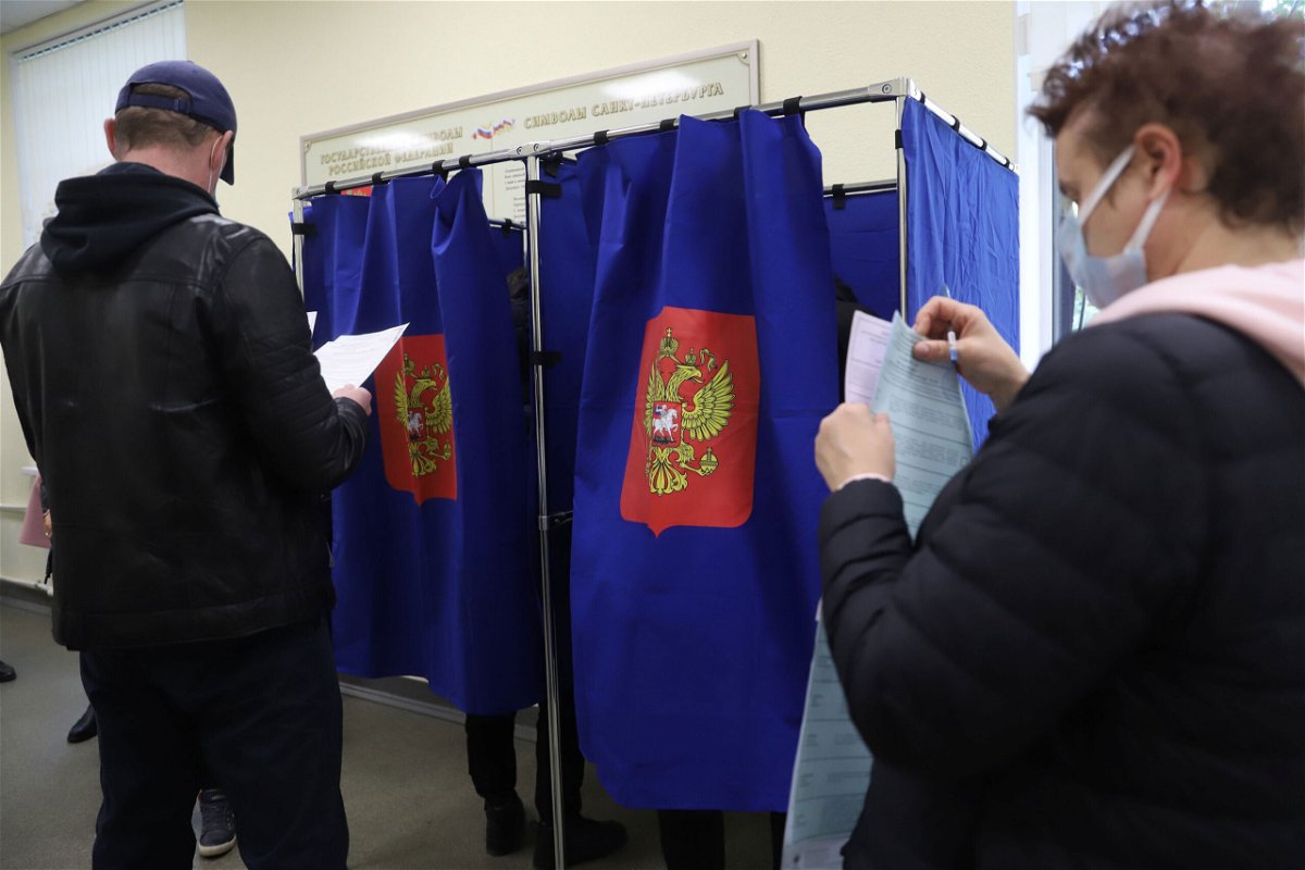 <i>Sergei Mikhailichenko/SOPA Image/Shutterstock</i><br/>People vote during the last day of the three-day parliamentary and local elections in Russia.