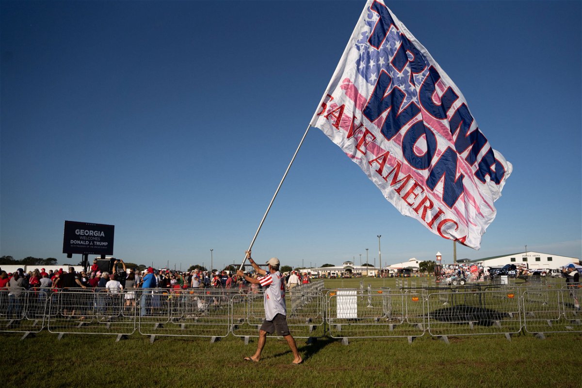 <i>Sean Rayford/Getty Images</i><br/>A man carries a flag that reads 