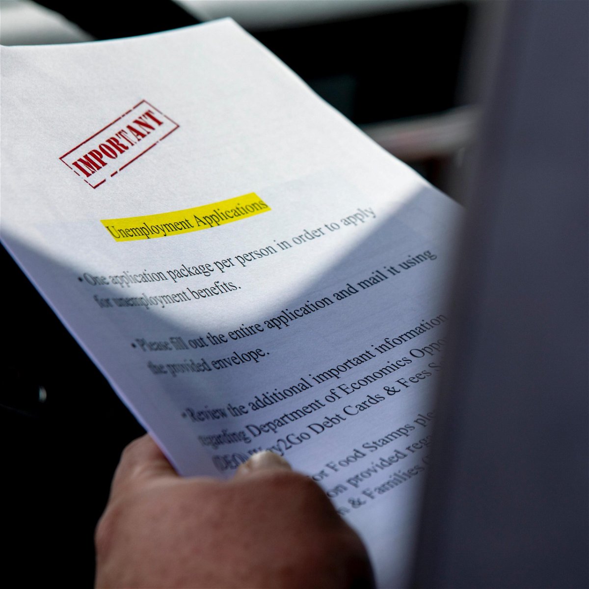 <i>Daniel A. Varela/Miami Herald/Tribune News Service/Getty Images</i><br/>A Miami-Dade County resident holds a paper unemployment form on April 7