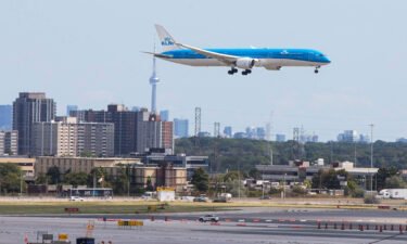 Canada is launching a standardized proof of vaccination credential for both domestic and international travel. An airplane is seen landing in Mississauga