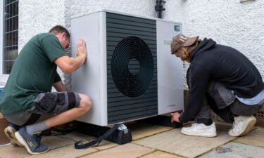 Workers from Solaris Energy installing an air source heat pump into a house in Folkestone