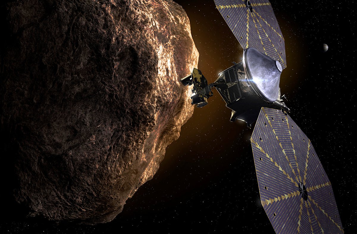 <i>Southwest Research Institute</i><br/>This illustration shows the Lucy spacecraft passing one of the Trojan asteroids near Jupiter.