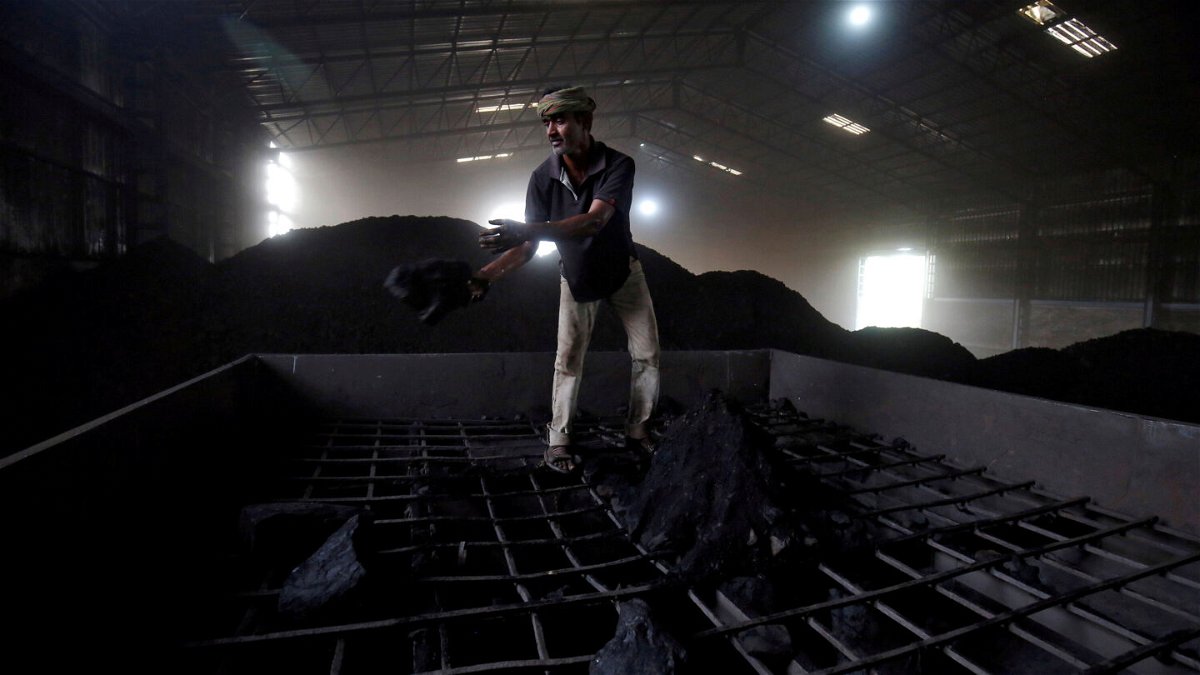 <i>Amit Dave/Reuters</i><br/>India may be staring at electricity shortages in the coming months because coal stocks at most of its power plants have dropped to critically low levels. A laborer is shown here working inside a coal yard on the outskirts of Ahmedabad