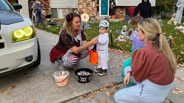 <i>KSL</i><br/>Crystal Conover (center) distributes glow sticks to children to help keep them safe at night while trick-or-treating.