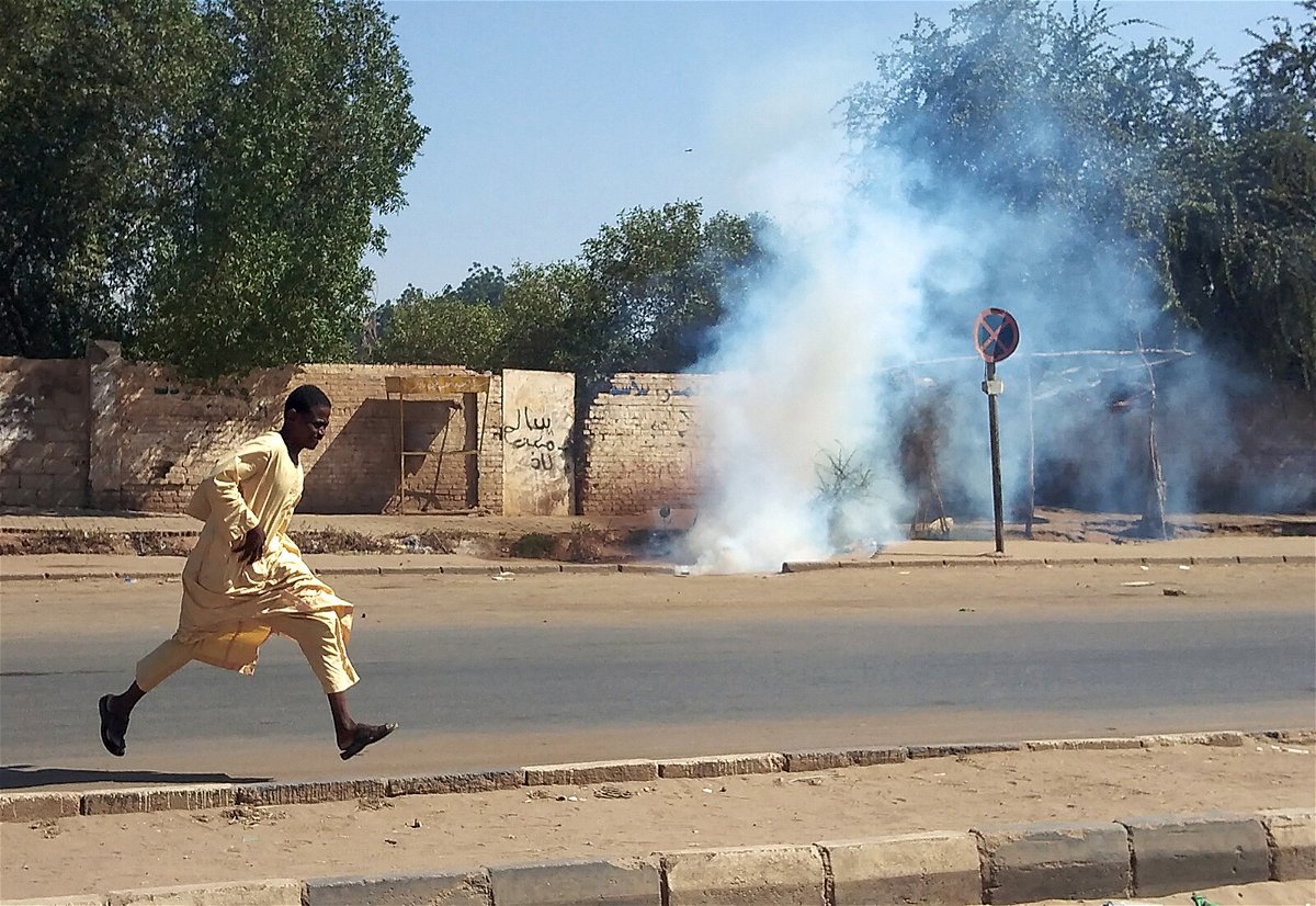 <i>AFP/Getty Images</i><br/>A Sudanese opponent of the military coup runs from tear gas launched by security forces during a protest in city of Umdurman