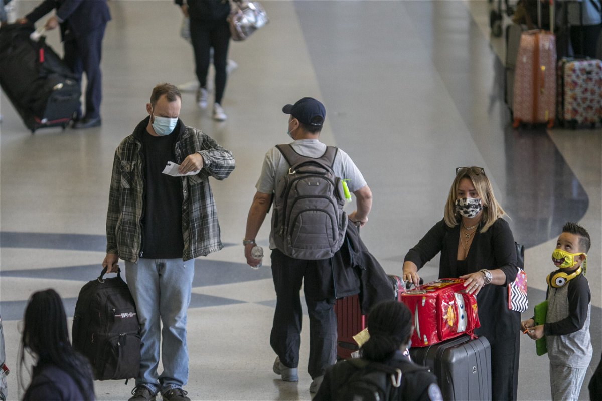 <i>David McNew/Getty Images</i><br/>Holiday travelers pass through Los Angeles International Airport in November of 2020. Air travel is expected to be up 80% for Thanksgiving this year.