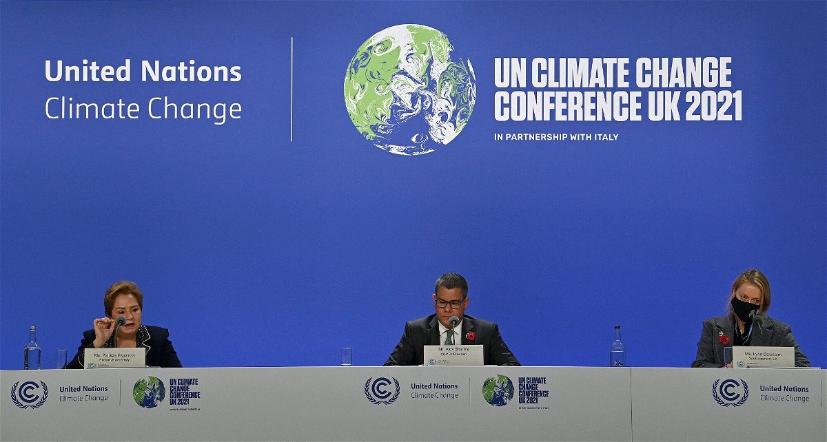 <i>PAUL ELLIS/AFP/AFP via Getty Images</i><br/>Britain's COP26 President Alok Sharma (C) and Executive secretary of the United Nations Framework Convention on Climate Change