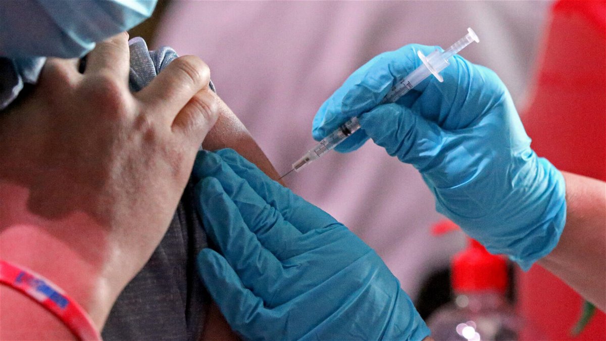 <i>Stuart Cahill/MediaNews Group/Boston Herald/Getty Images</i><br/>Millions of US workers are already required to show proof of a Covid-19 vaccine to their employer. Soon many could be forced to show proof that they also got a booster shot.