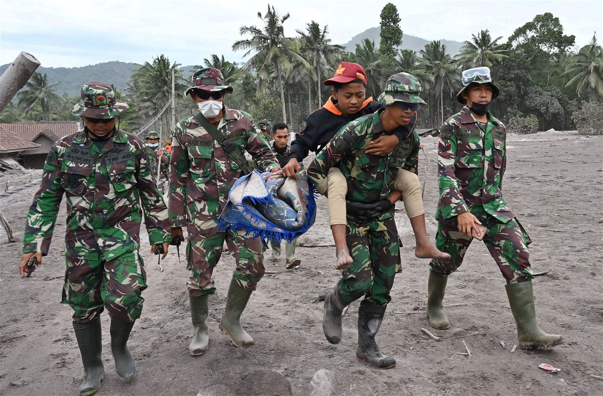 <i>Adek BerryAFP/Getty Images</i><br/>Members of a search and rescue team carry a villager during an operation at the Sumberwuluh village on December 6.