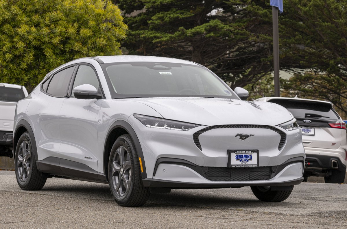 <i>David Paul Morris/Bloomberg/Getty Images</i><br/>Ford is increasing output for its Mustang Mach-Es in 2022. Pictured is the Ford Mustang Mach-E electric sports utility vehicle at a dealership in Colma