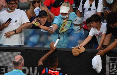 Kyrgios (bottom C) gives a racket to a boy he had hit with a tennis ball.