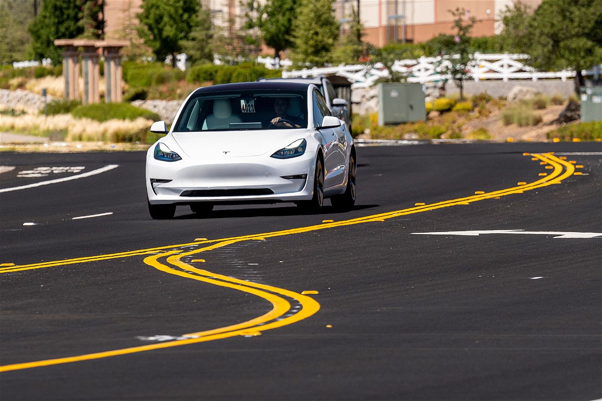 <i>David Paul Morris/Bloomberg/Getty Images</i><br/>Tesla owners complain about 'phantom braking.' A Tesla Model 3 here travels on a road in Rocklin
