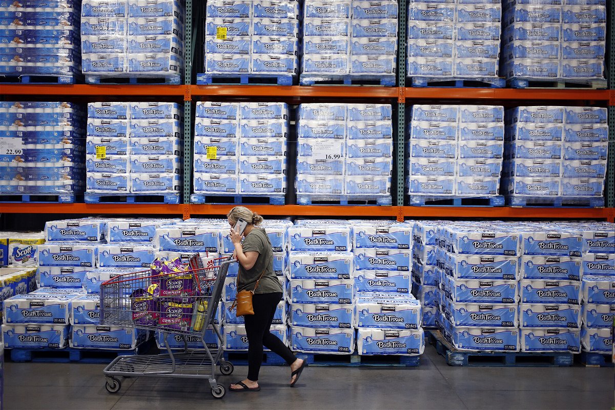 <i>Luke Sharrett/Bloomberg/Getty Images</i><br/>A customer pushes a shopping cart past pallets of toilet paper at a Costco Wholesale Corp. store in Louisville