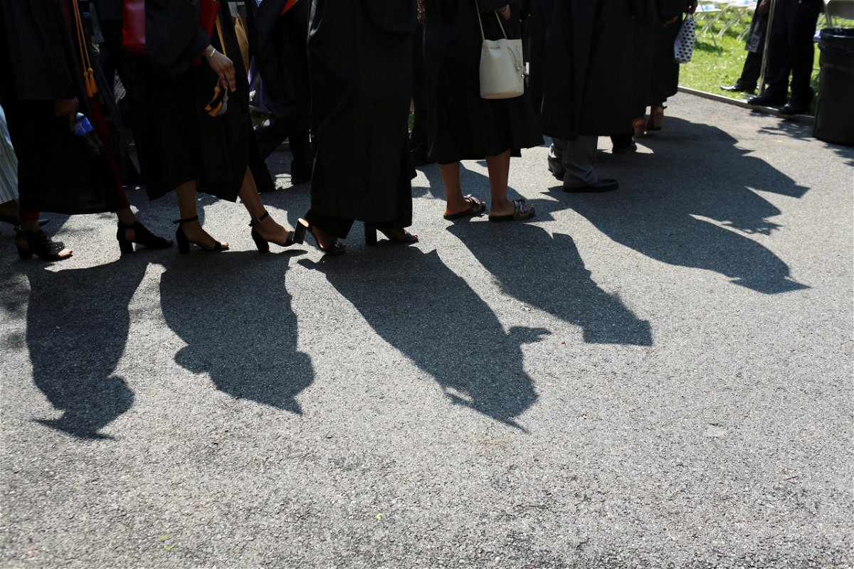 <i>GABRIELA BHASKAR/REUTERS</i><br/>College graduates walk to their seats at their commencement ceremony in Manhattan in 2019.