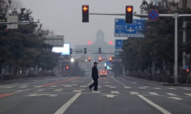 Seen here is a man walking across an empty road in Changchun