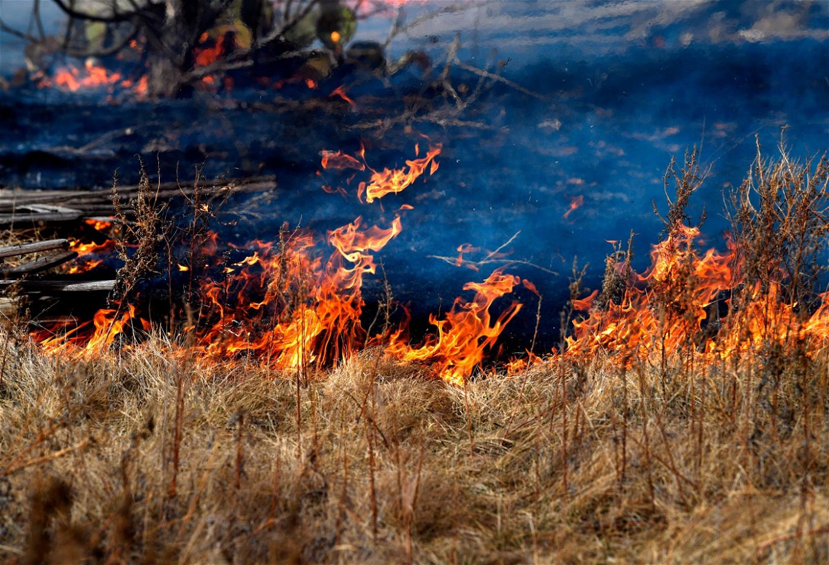 <i>Ronald W. Erdrich/AP</i><br/>Fire burns into dry grass near West Highway 80 in Abilene