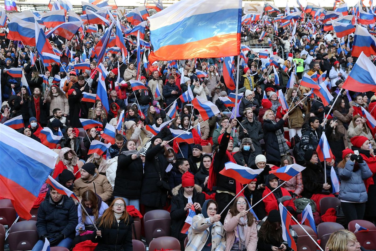 <i>Getty Images</i><br/>Russians hold flags and cheer during the concert that featured live music and speeches from high-profile Putin supporters.
