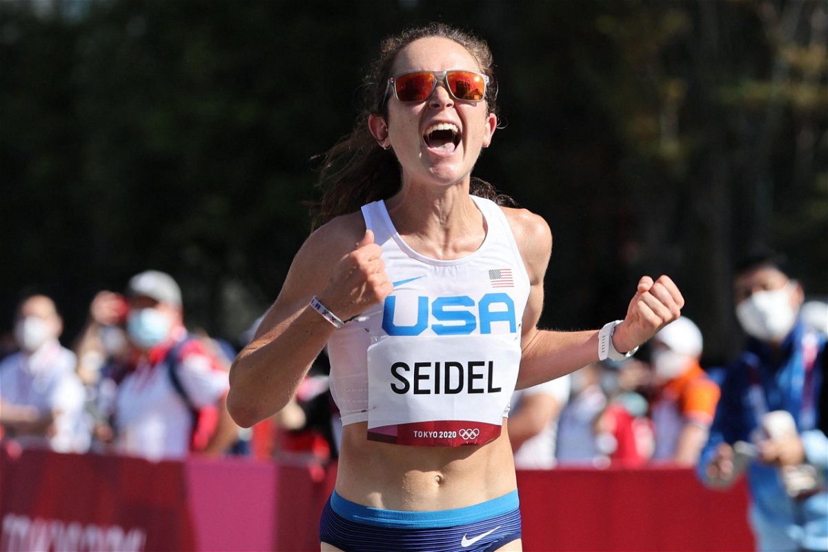 <i>GIUSEPPE CACACE/AFP/AFP via Getty Images</i><br/>Molly Seidel celebrates as she crosses the finish line of the women's marathon at the Tokyo 2020 Olympic Games in Sapporo on August 2021.