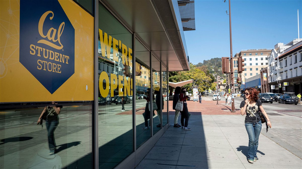 <i>David Paul Morris/Bloomberg via Getty Images</i><br/>A person walks past the student store on the University of California