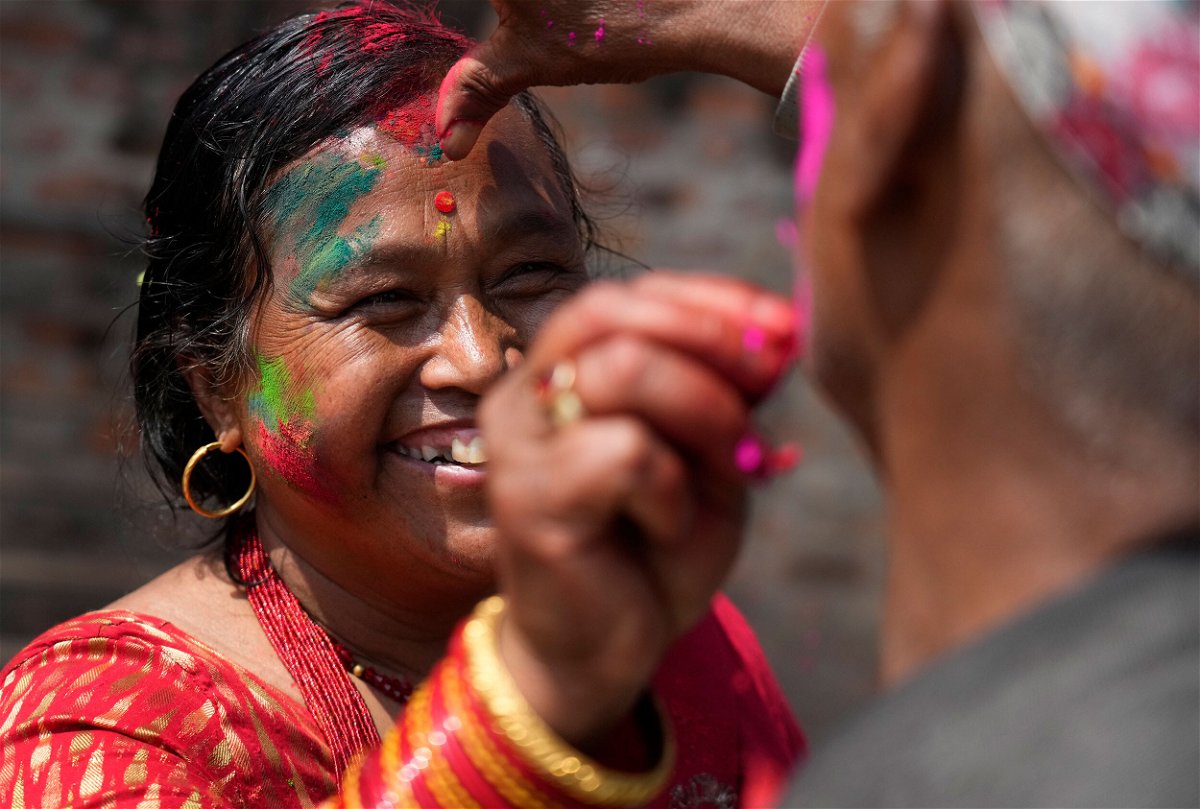 <i>Niranjan Shrestha/AP</i><br/>People apply colored powder on each other during Holi celebrations in Bhaktapur