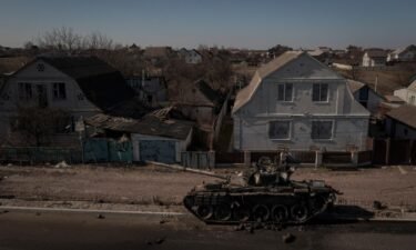 A destroyed tank sits on a street after battles between Ukrainian and Russian forces on a main road near Brovary