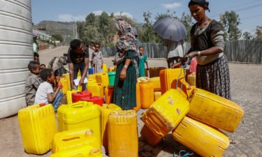 Civilians fill plastic containers with water in Lalibela