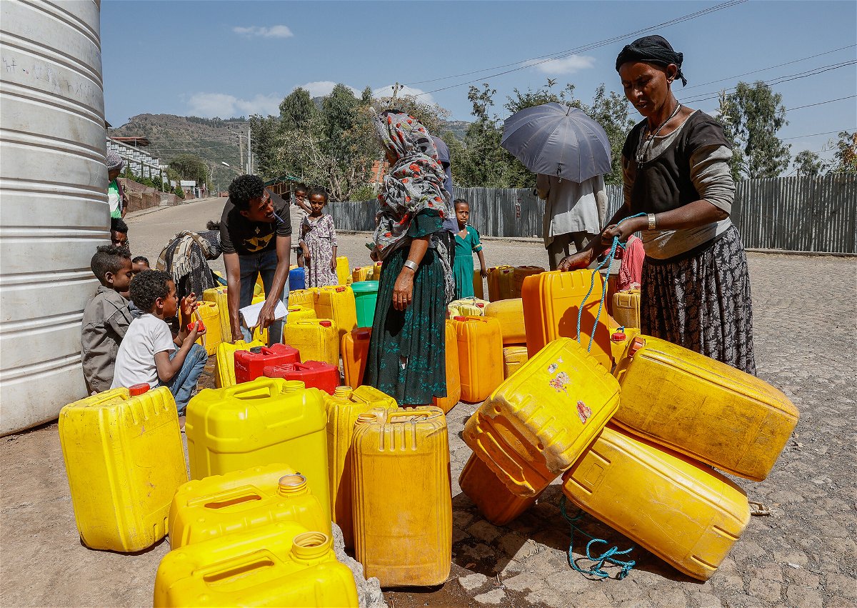 <i>J. Countess/Getty Images</i><br/>Civilians fill plastic containers with water in Lalibela