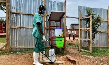 A medical worker disinfects an Ebola treatment center on March 21
