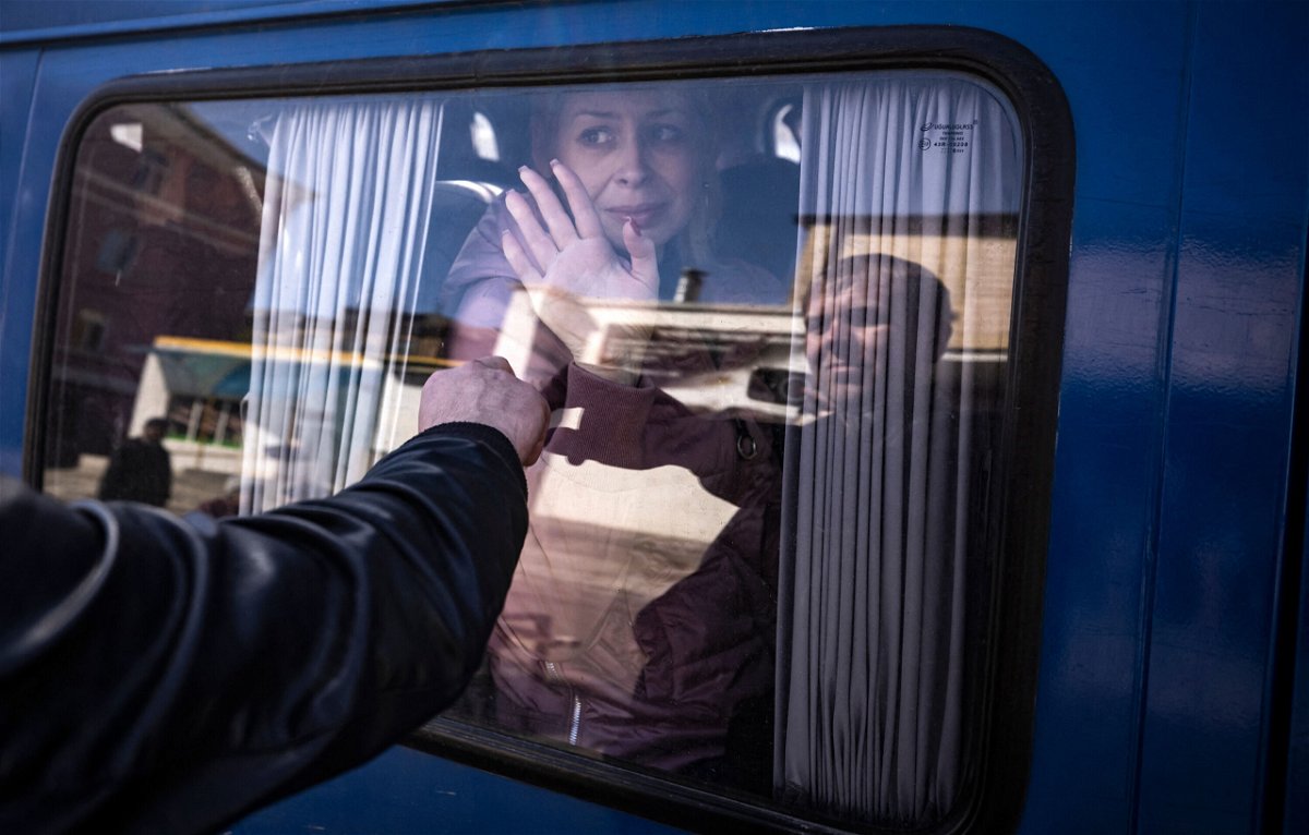 <i>Fadel Senna/AFP/Getty Images</i><br/>A woman waves to say good bye to her husband as she leaves on a bus