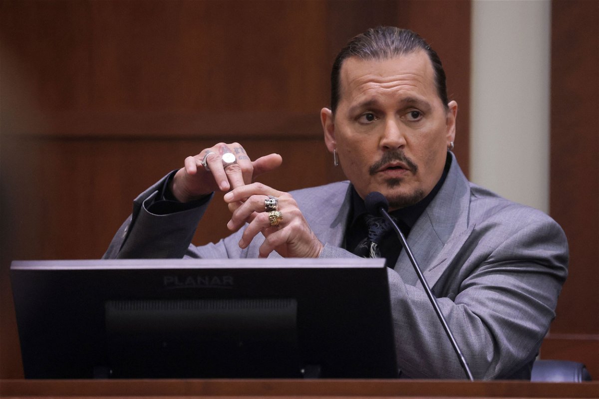 <i>Evelyn Hockstein/Pool/AFP/Getty Images</i><br/>Johnny Depp displays the middle finger of his hand in court