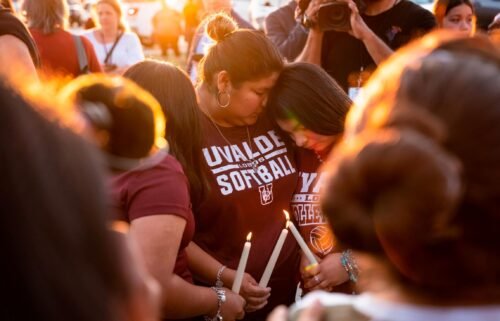 Attendees light candles during a memorial held for the 19 children and two teachers who were murdered by an 18-year-old gunman at Robb Elementary School the day before