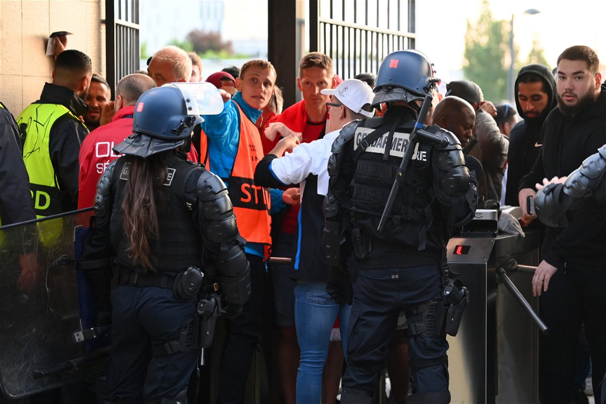 <i>Matthias Hangst/Getty Images</i><br/>Police and stewards stand at the turnstiles as fans queue ahead of the Champions League final.