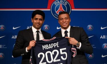 Kylian Mbappe turned down the chance to sign for Real Madrid. Paris Saint-Germain's CEO Nasser Al-Khelaifi (L) and French forward Mbappe (R) pose with a jersey at the end of a press conference in Paris on May 23.