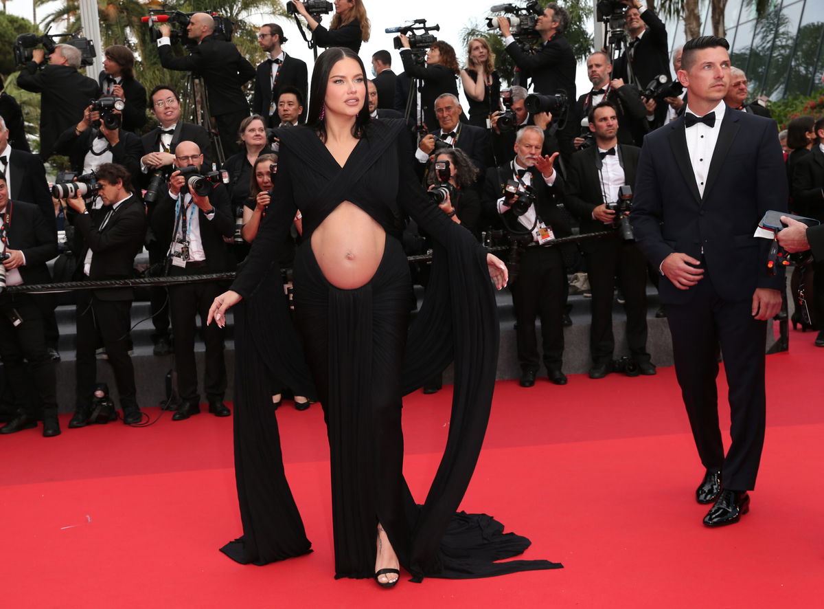 Adriana Lima shows off baby bump on Cannes red carpet