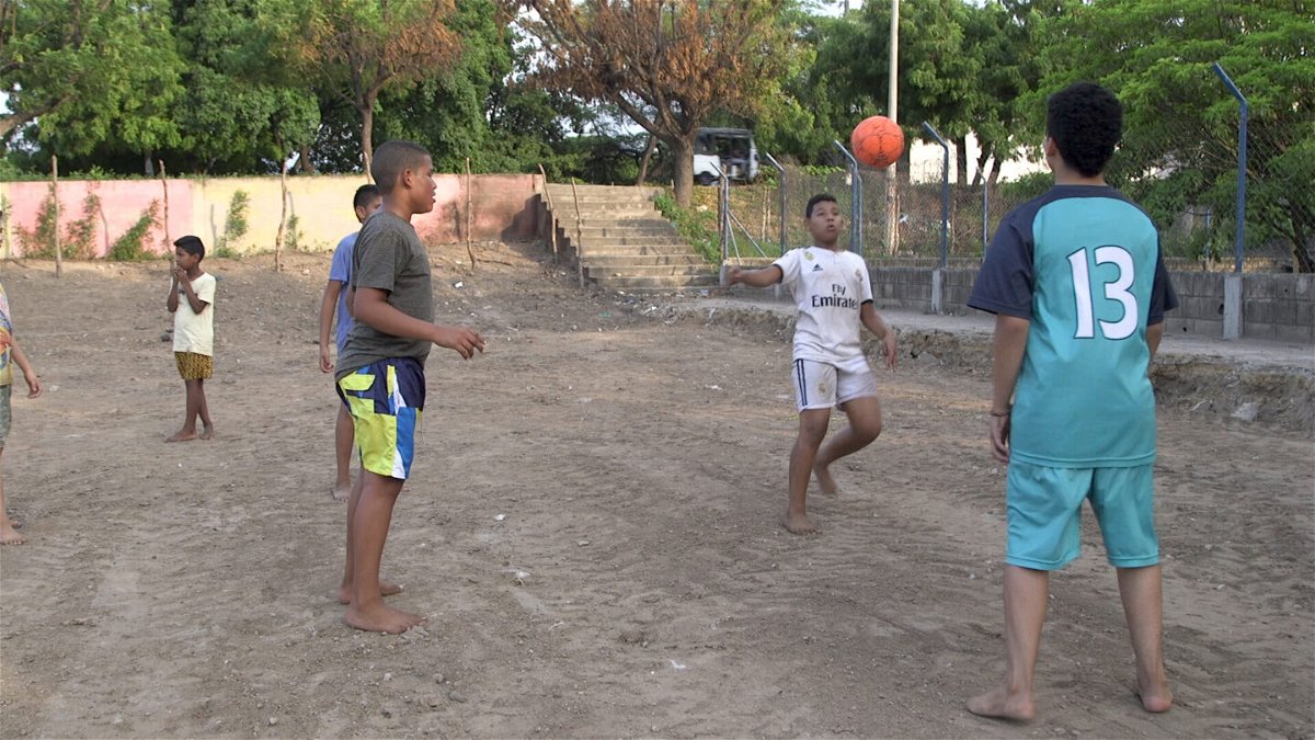 <i>Stefano Pozzebon/CNN</i><br/>Luis Diaz's family gripped by son's football odyssey as they watch from afar in Colombia. Barefoot kids are pictured playing football on the sandy pitch in front of Diaz's family home in Barrancas on May 14.