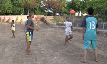 Luis Diaz's family gripped by son's football odyssey as they watch from afar in Colombia. Barefoot kids are pictured playing football on the sandy pitch in front of Diaz's family home in Barrancas on May 14.
