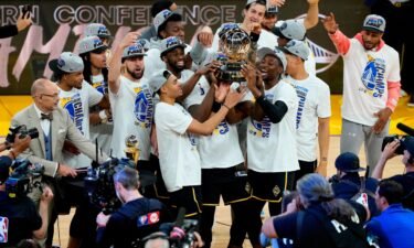 The Warriors celebrate with the Western Conference Champion trophy after a 120-110 win against the Dallas Mavericks.