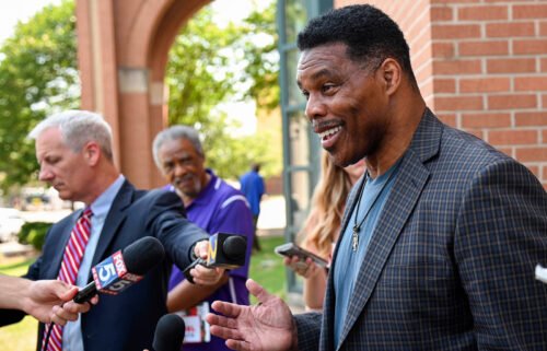 Republican Senate candidate Herschel Walker speaks with reporters after a campaign rally at the Georgia Sports Hall of Fame in Macon on May 18.